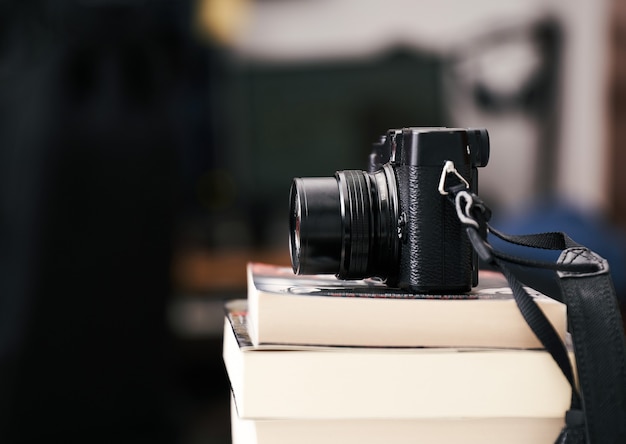 Vintage camera on pile of books