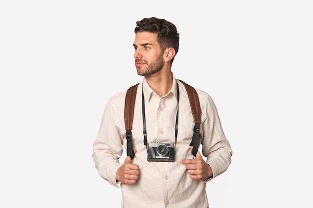 Vintage camera slung over young photographer's shoulder