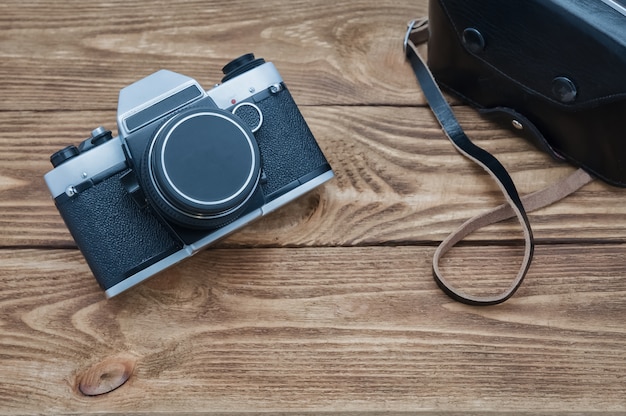 Vintage camera on textured boards table.