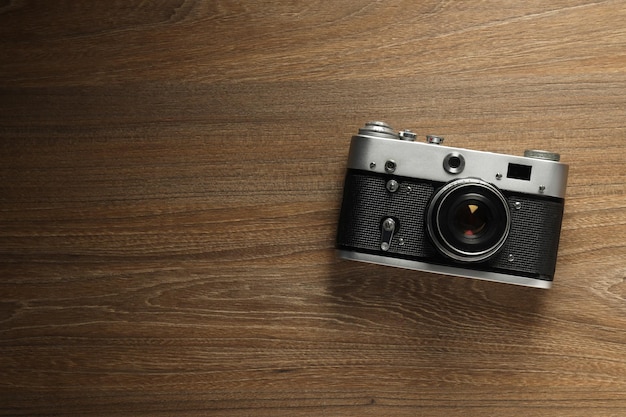 Vintage camera on wooden background space for text