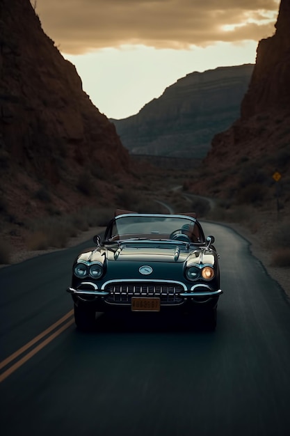 A vintage car drives down a road in the desert.