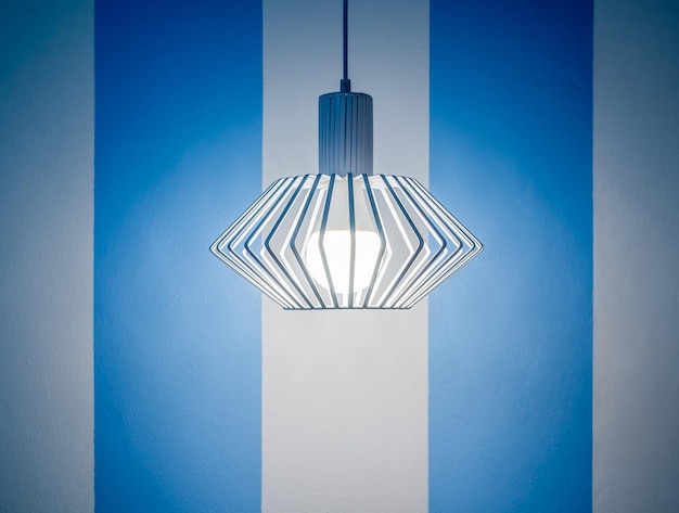 Vintage ceiling lamp on white and blue wall background