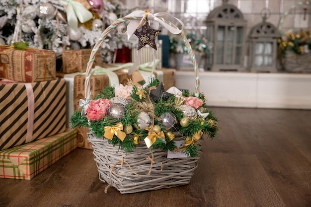 Vintage Christmas decoration in Magic Composition with Basket. colorful balls, Pine cones, Sweet Candy, fir branches, Walnuts and snowflakes. Country style. festive decoration.Christmas wicker basket