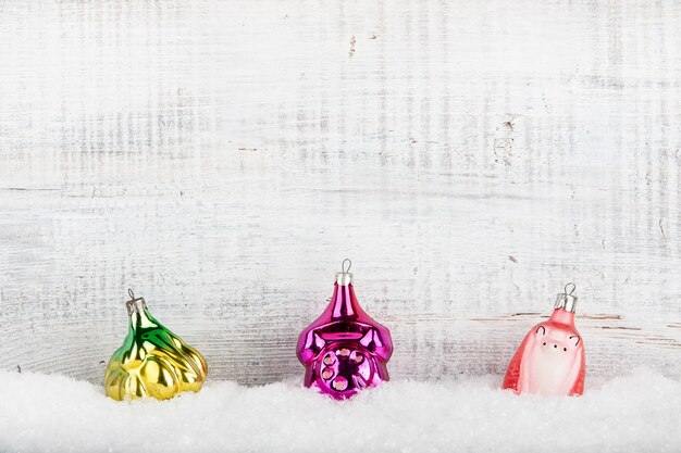 Vintage Christmas decorations in snow on wooden background