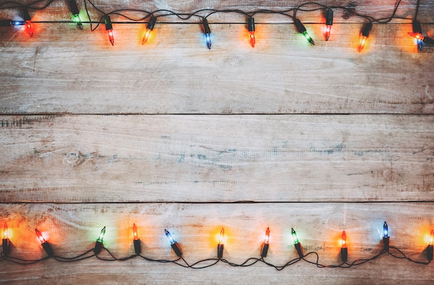 Vintage Christmas lights bulb decoration on old wood plank