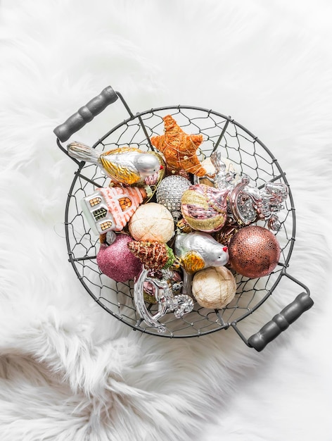 Vintage Christmas toys in a metal basket on a fluffy carpet top view