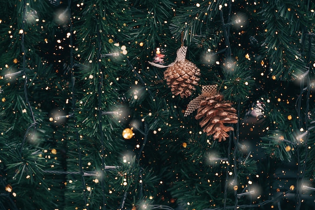 Vintage Christmas tree with pine cone decoration and sparkle light. 