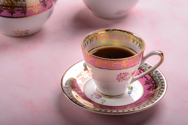 Vintage coffee cup over pink marble