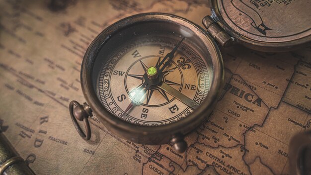 Vintage compass on old world map