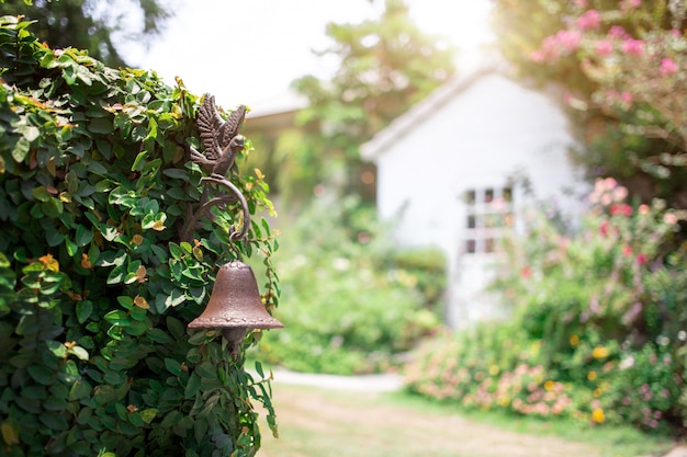 Vintage copper bell decoration plant wall gate vintage house with garden