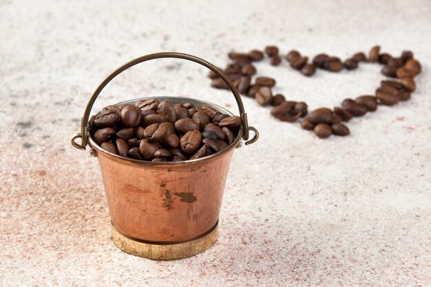 Vintage copper bucket on concrete background