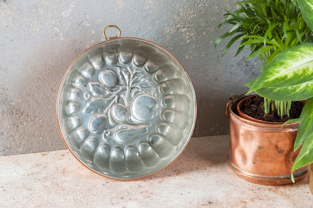 Vintage copper mold on a concrete background.