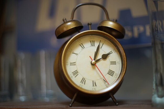 Vintage coppercolored alarm clock on the cabinet shelf