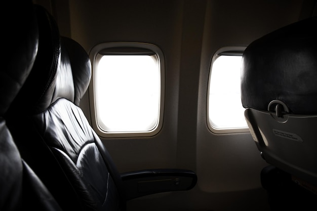 Vintage dark tone of seats in economy class passenger on aircraft Empty airplane seats in the cabin