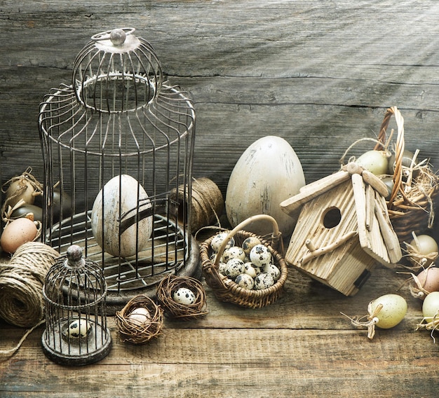 Vintage easter decoration with eggs, birdhouse and birdcage. nostalgic style picture with sun beams effect