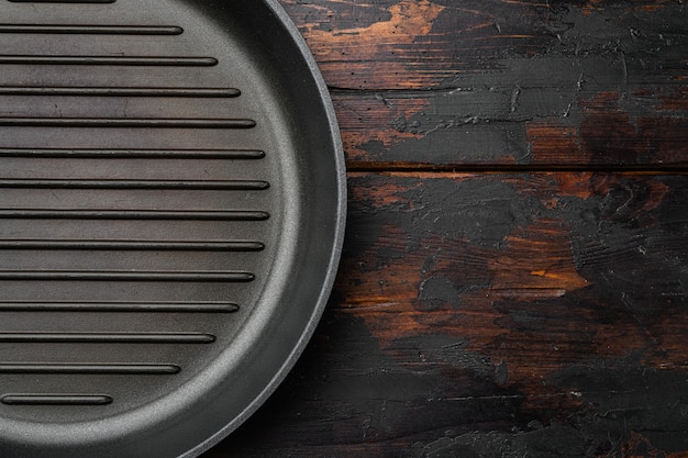 Vintage empty grill pan set with copy space for text or food with copy space for text or food, top view flat lay, on old dark  wooden table background