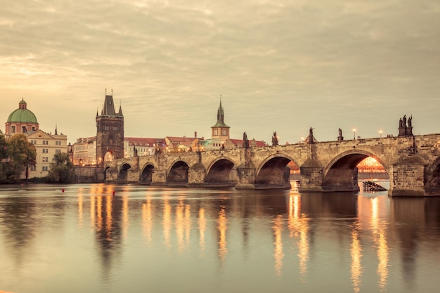 Vintage Famous Prague Landmarks towers and bridge at night time with city illuminated Prague Czech Europe