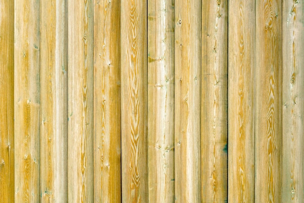 Vintage fence of old wooden boards Texture of an aging wooden surface Beautiful wooden background