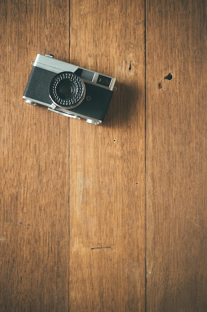 Vintage film camera on wooden table