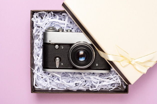 Vintage gift box on a pink background, top view