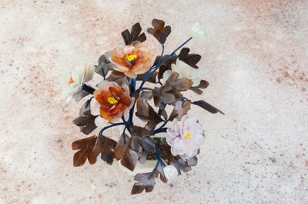 Vintage glass flowers on concrete.