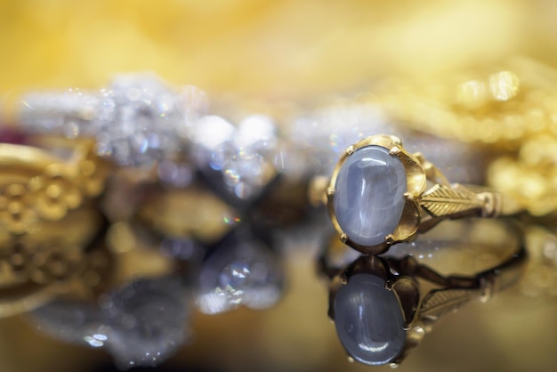 Vintage gold Jewelry blue sapphire rings with reflection on black background