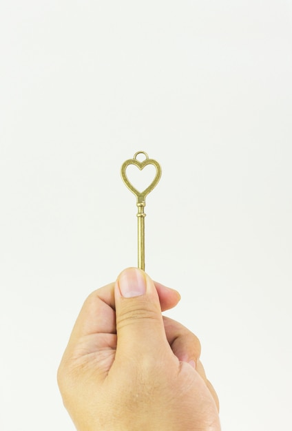 Vintage gold key in hand close up image.