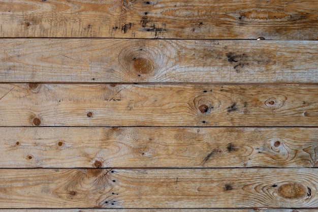 Vintage gray wood background texture with knots and nail holes Brown abstract background Vintage wooden dark boards Front view with copy space