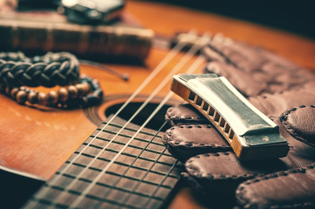 Vintage harmonica on acoustic guitar