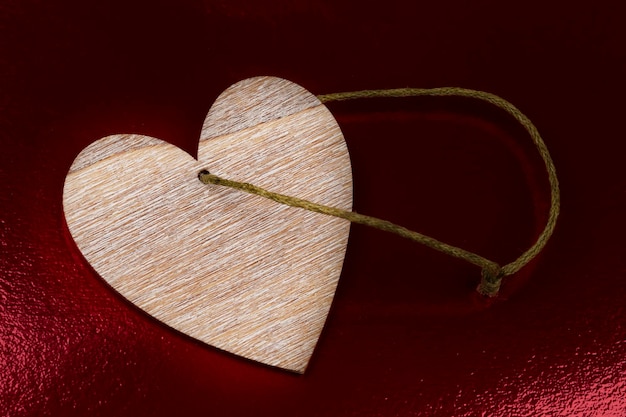 Vintage heart made of wood on a dark red background