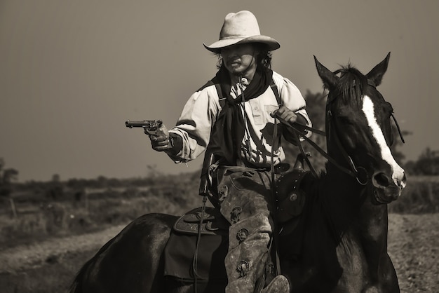 Vintage image of cowboy Showing horse riding, and shooting guns