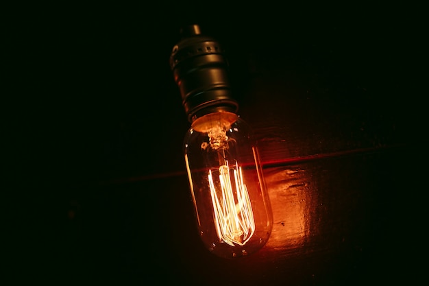 Vintage incandescent Edison type bulbs on wooden wall