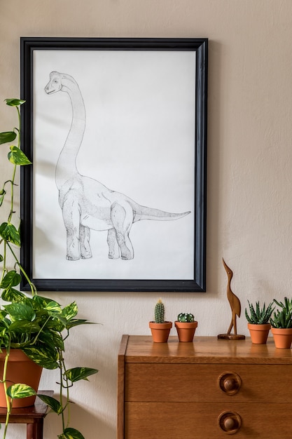 Vintage interior design of living room with design retro wooden commode, plants composition, accessories and black mock up poster frame on the beige wall. Stylish home decor. Template.