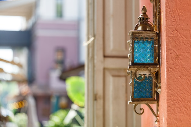 Vintage iron lantern on the wall outdoor in street cafe