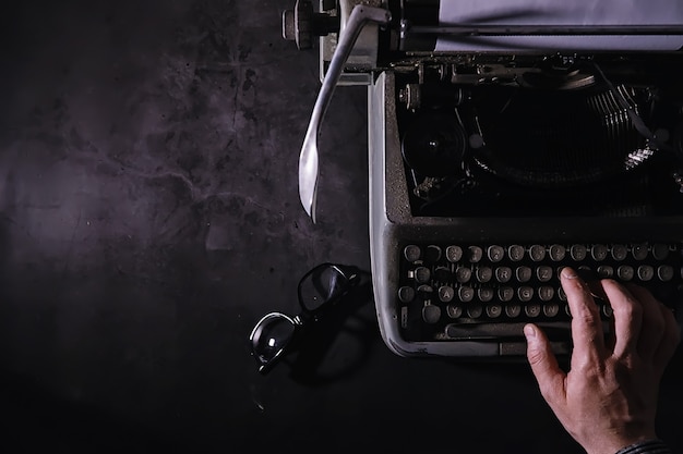 Vintage journalist tool. typewriter retro. the writer is at\
work. seal of the novel. journalist writer concept.