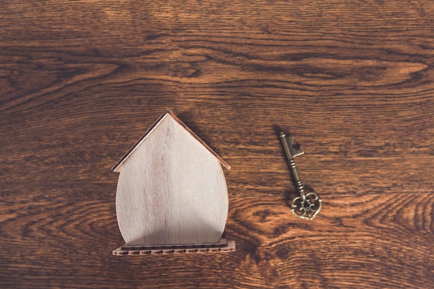 Vintage key and house model on desk