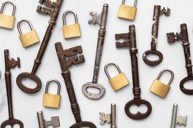 Vintage keys and padlocks overhead lay flat composition\
security concept