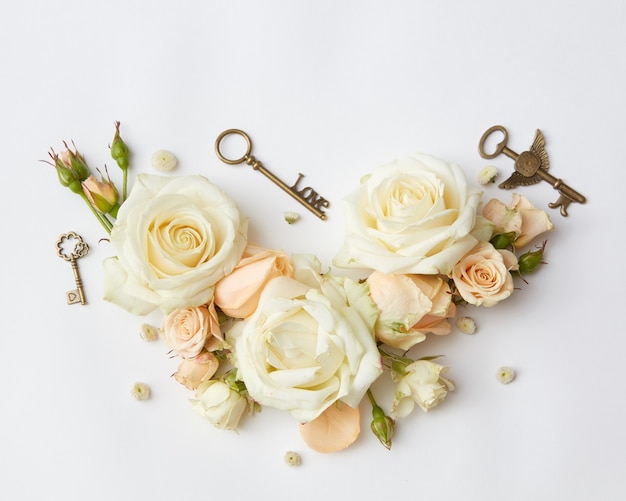 Vintage keys with beige roses, Flat lay.