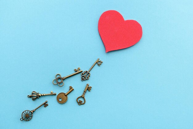 Photo vintage keys with a red heart valentine's day background the concept of the key to the heart