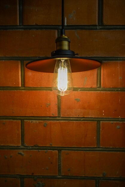 Vintage lamp on brick background