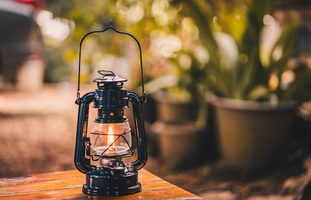 Vintage latern hanging on the table in the evening