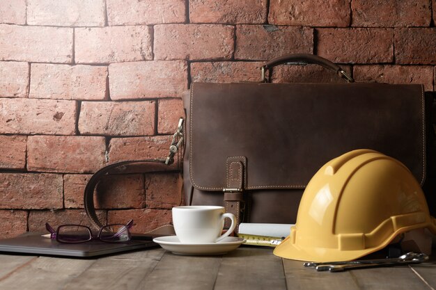 Vintage leather bag with safety helmet and tool 