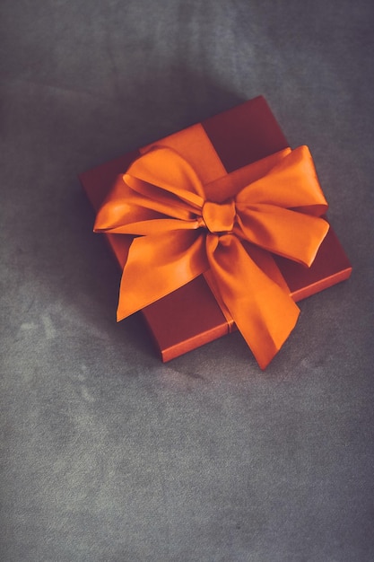 Vintage luxury holiday orange gift box with silk ribbon and bow christmas or valentines day decor