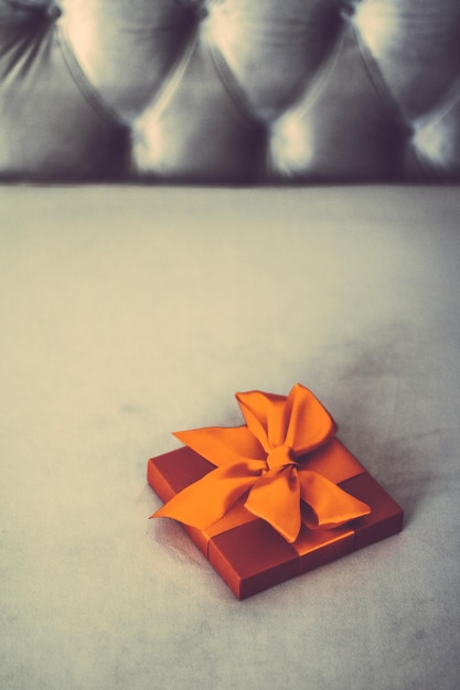 Vintage luxury holiday orange gift box with silk ribbon and bow christmas or valentines day decor