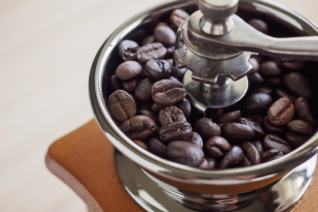 Vintage manual coffee grinder with roasted coffee beans