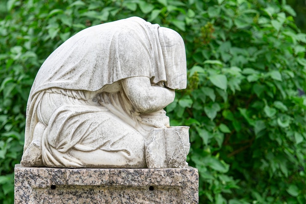 Vintage marble statue at an old graveyard or cemetery