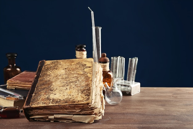 Vintage medicine bottles and books on wooden table