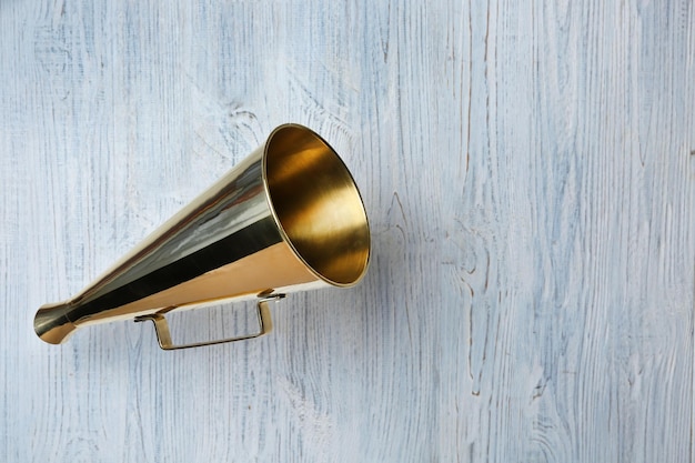 Vintage megaphone on wooden background