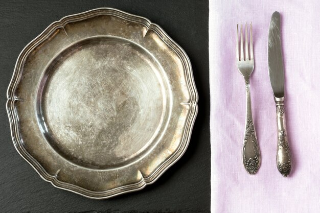 Photo vintage metal dish with silverware