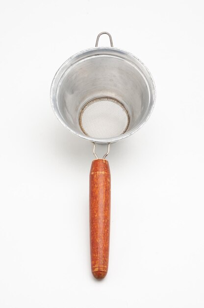 Vintage metal strainer for kitchen on isolated white background